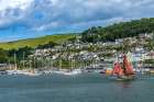 Red sailboat sailing, Dartmouth, Kingswear, Devon, England. Art Print